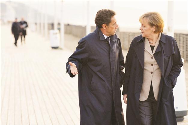 Merkel and Sarkoz vow fast action as crisis bites