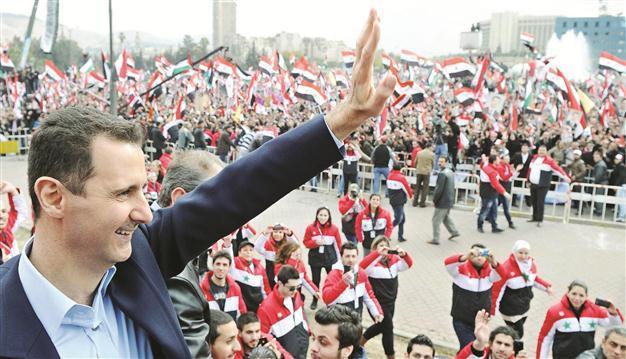 Assad takes defiant message to street