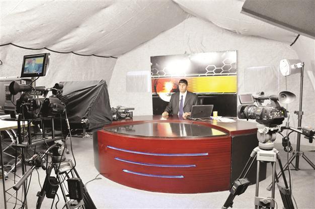 Local TV broadcasting in a tent in quake-hit town
