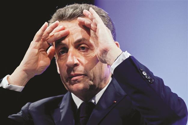 Defections and poll plunge hit Sarkozy