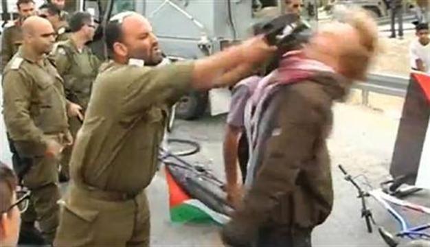 Israel suspends officer who hit protester with gun