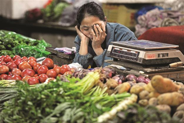 China’s inflation eases, as economy slows further