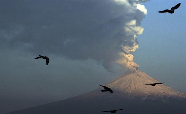 Mexico volcano spews glowing rock, tower of ash