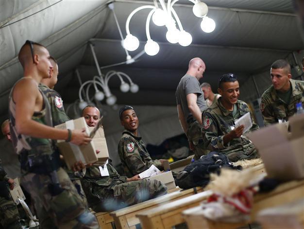 NATO troops watch Games with weapons at hand