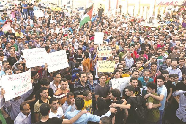 Palestinian premier under fire as protests fill streets