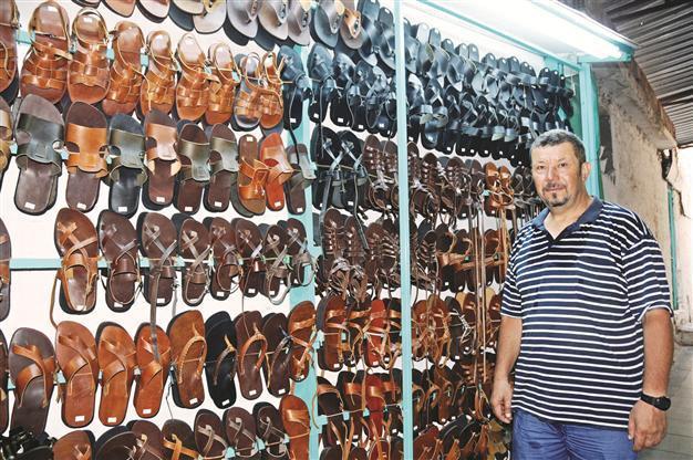 Sandal-making master resists technology using basic tools