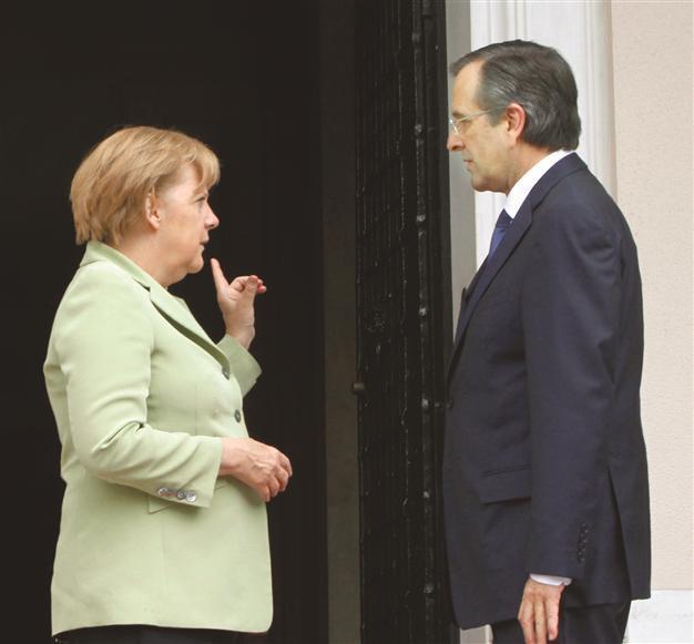 Merkel encourages Greece amid protests