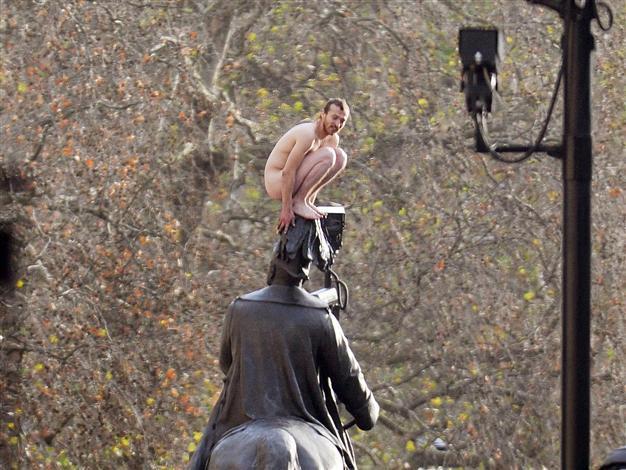 Man in naked standoff on statue in central London