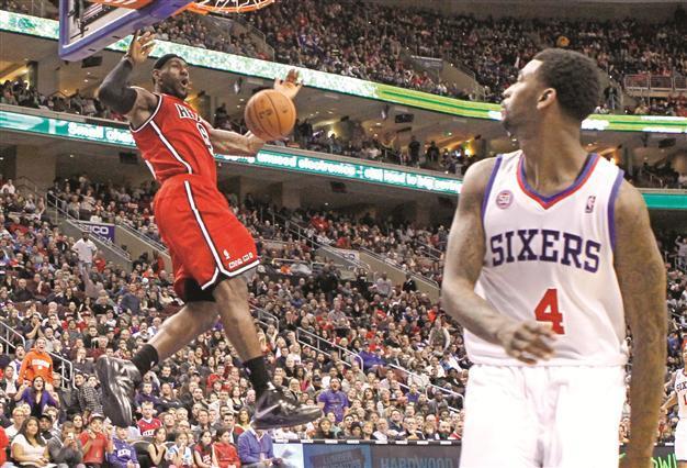 Heat beat 76ers with James triple-double