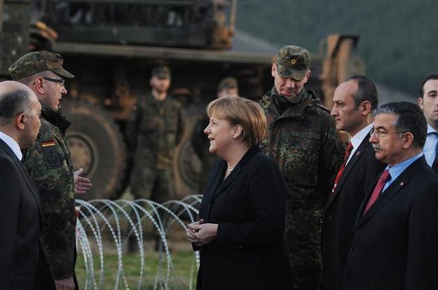 Merkel launches busy trip at site of Patriots