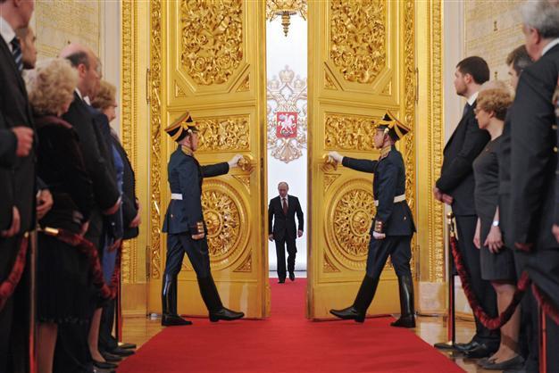 Putin marks year since election at peak of power