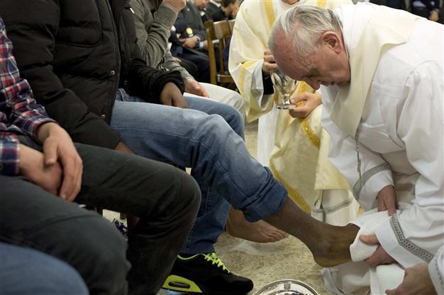 Pope washes womens feet in break with church law