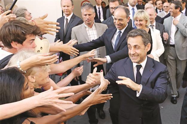 France’s Sarkozy back on stage to save UMP