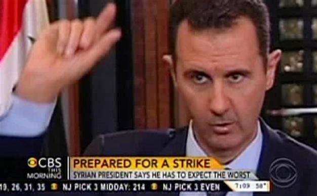 Assad warns US will pay the price if it attacks Syria