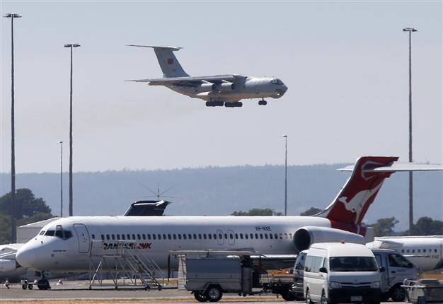 Storms ground MH370 air search after new debris sighting