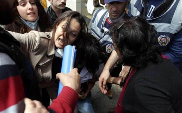 Police try to detain opposition deputy Şafak Pavey as she helps a young protester