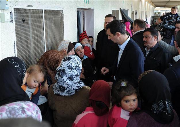 Assad visits displaced Syrians outside Damascus: TV