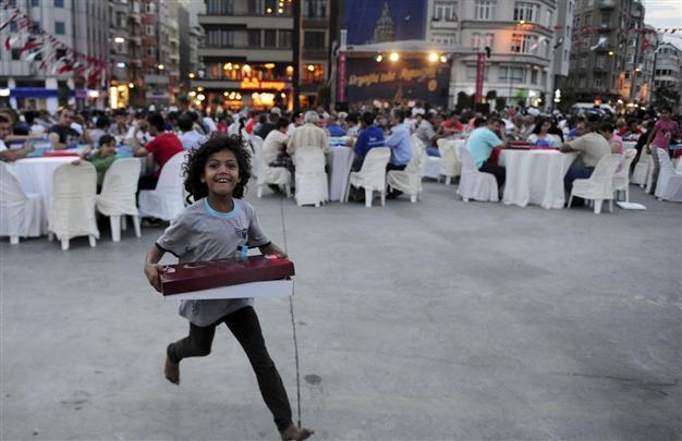 Syrian refugee children strive to get free food during iftar dinners in central Istanbul