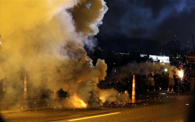 Two shot, dozens arrested in Ferguson after night of protests