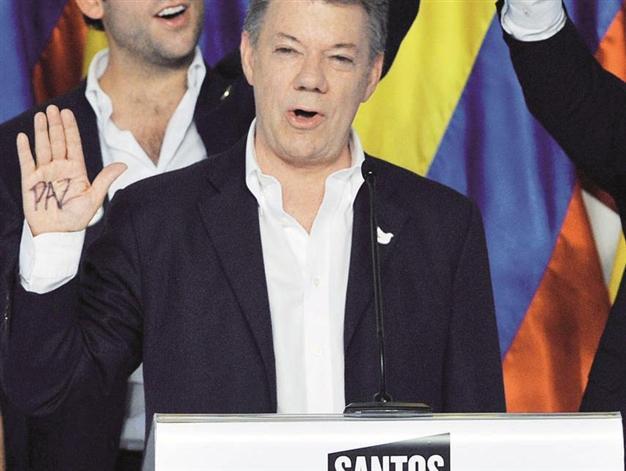 Santos re-elected in Colombia, tells FARC it’s time for peace