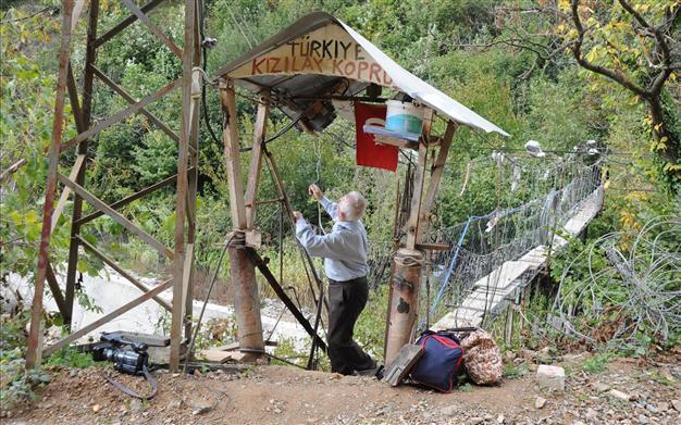 Locals draw blood to cross wooden suspension bridge in Black Sea village