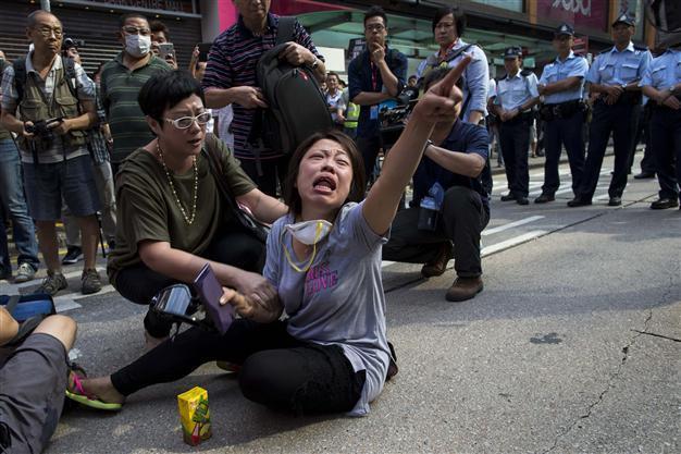 Hong Kong police clear protesters, barricades at key site