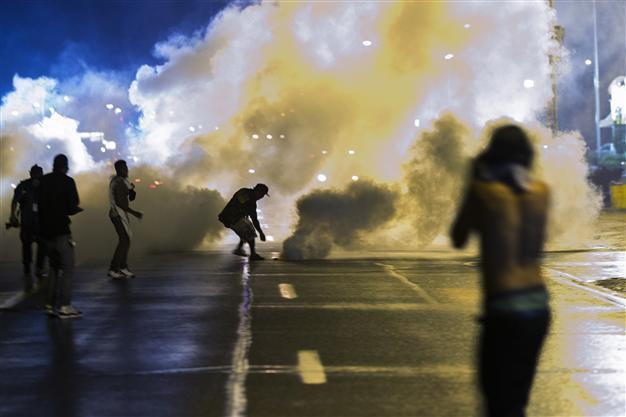 One shot, seven arrested as violence flares in riot-hit US town