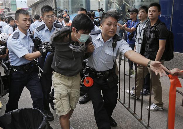 Hong Kong riot police clear protest site, arrest student leaders