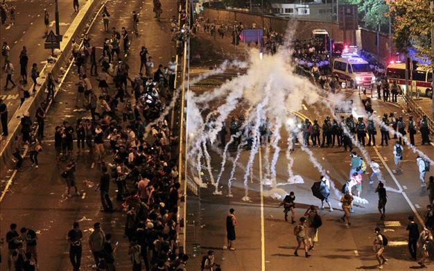 Hong Kong protesters defy tear gas and batons to renew democracy call