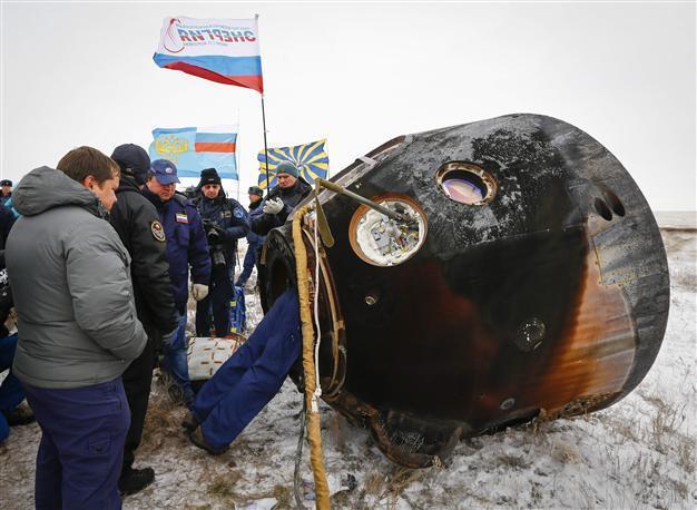Three-man multinational space crew returns to Earth