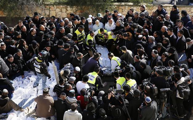Hollande vows France will never yield as terror victims buried