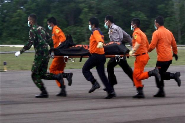 Divers find bodies belted in seats near AirAsia fuselage