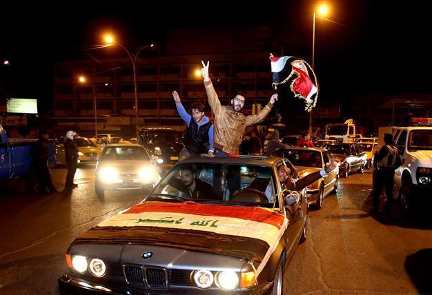 Iraqis fete curfew end with flags, horns and tyre smoke
