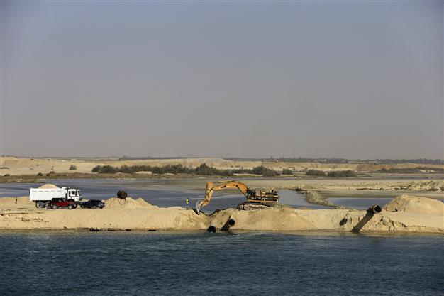 Egyptians race to expand Suez Canal, hoping for trade surge