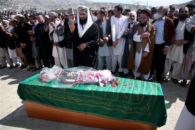 Afghans bury woman beaten to death by mob