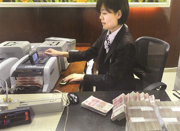 China cuts bank reserve ratio requirement as growth slows