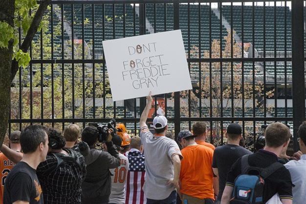 Baltimore protesters defy curfew after police officers charged