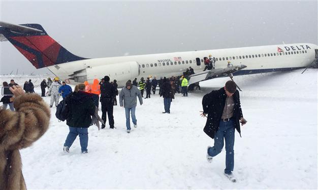 Plane skids off New York runway as winter storm hits US