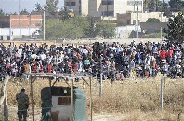Turkish forces push massing Syrians from border