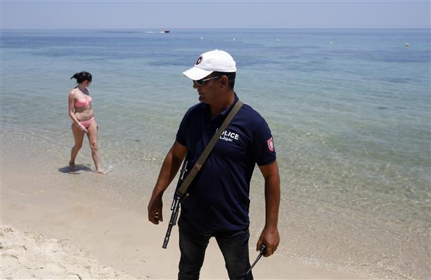 Armed Tunisian police swarm streets of tourist towns