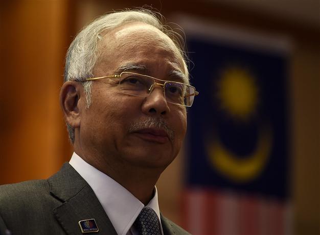 Malaysian police raid 1MDB office, PM weighs legal options