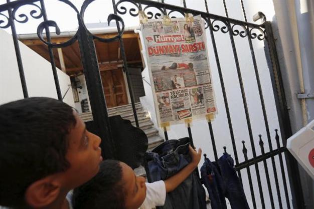 Turkey charges four Syrians over boat deaths as journalists flock to migrant beach
