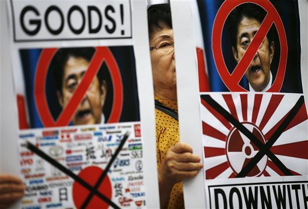 Japan economy shrinks in setback for ‘Abenomics’