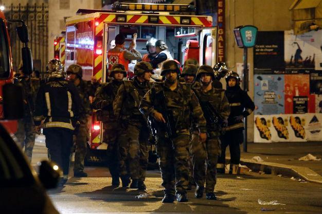 Suspect arrested over Paris attacks as raids continue across France