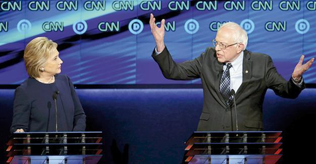 Clinton dodges bullets by Sanders, hits out at Trump