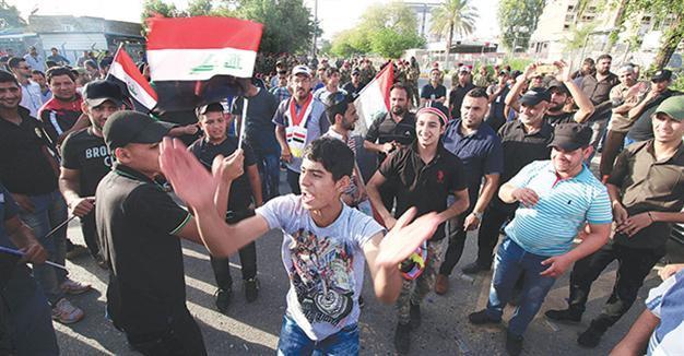 Iraqi MPs approve partial cabinet as thousands protest