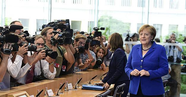 Merkel defends refugee stance after attacks