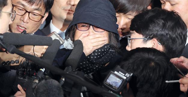 Prosecutors detain woman at core of South Korea political crisis