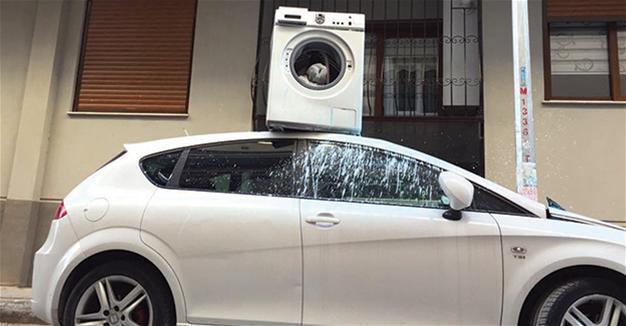 Angry Turkish man hurls washing machine from balcony onto parked car