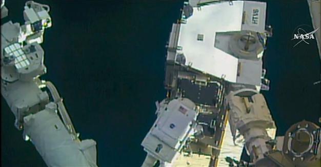 Spacewalking astronauts upgrade orbiting labs power grid